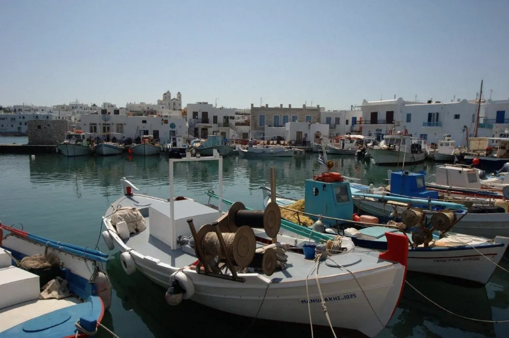 Naoussa harbour in Paros with fishing boats and the old sea wall